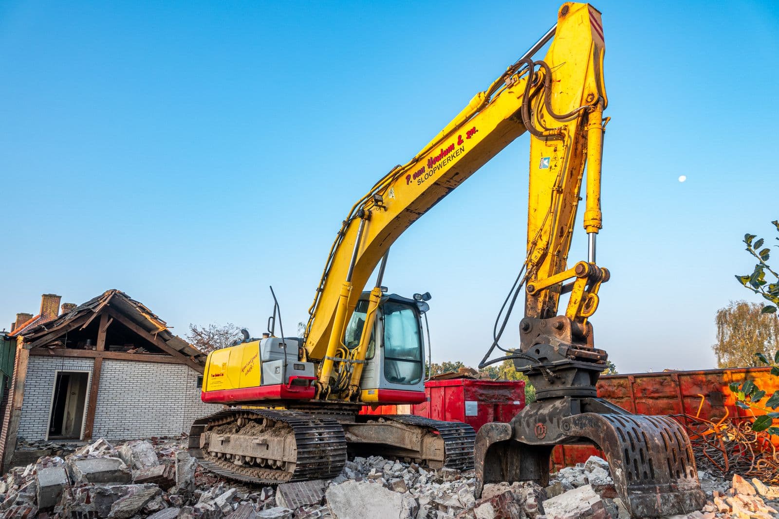 Excavator moving rubble at a construction site